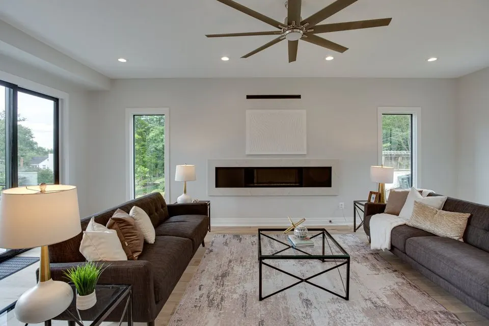 Living room with recessed ceiling lights and a large ceiling fan, from the Manny Source Electric Google profile