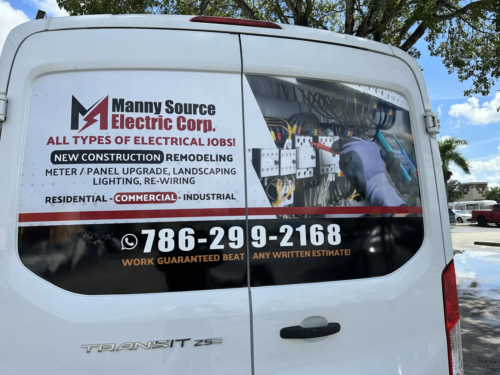 The back of the Manny Source Electric van, lettered with the phone number and residential, commercial and industrial